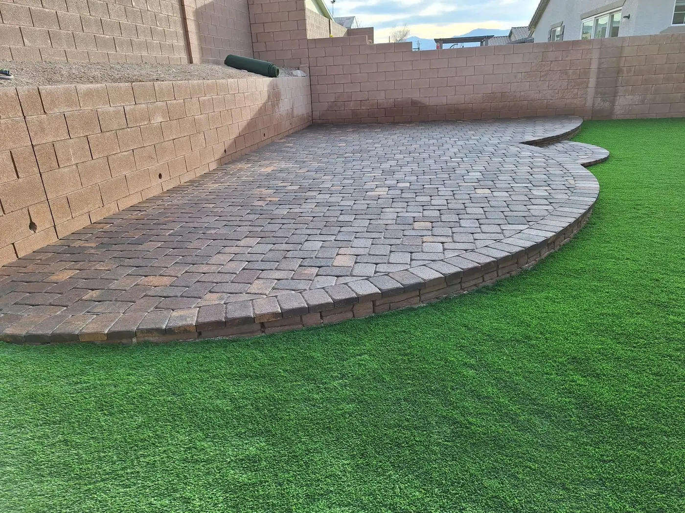 Curved paver patio next to turf