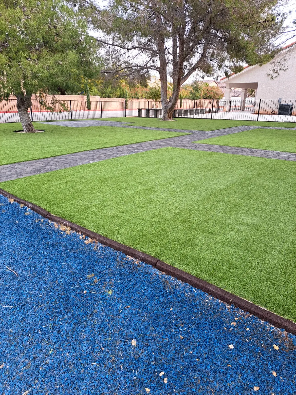 Artificial turf play area with a colored rubber border