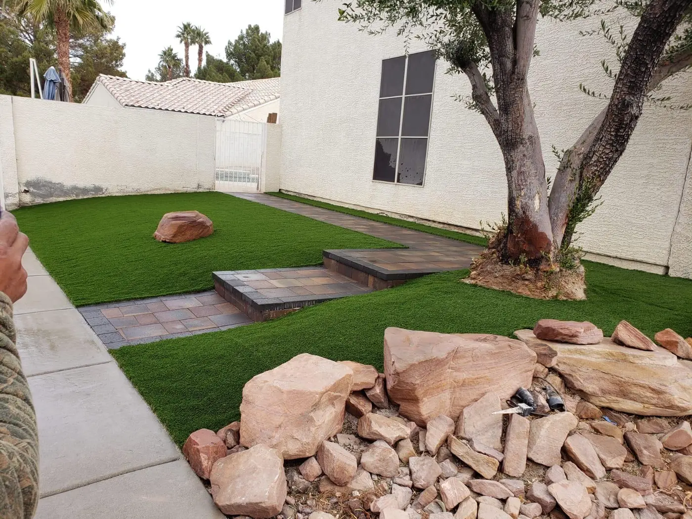 Boulders and rock beside artificial turf